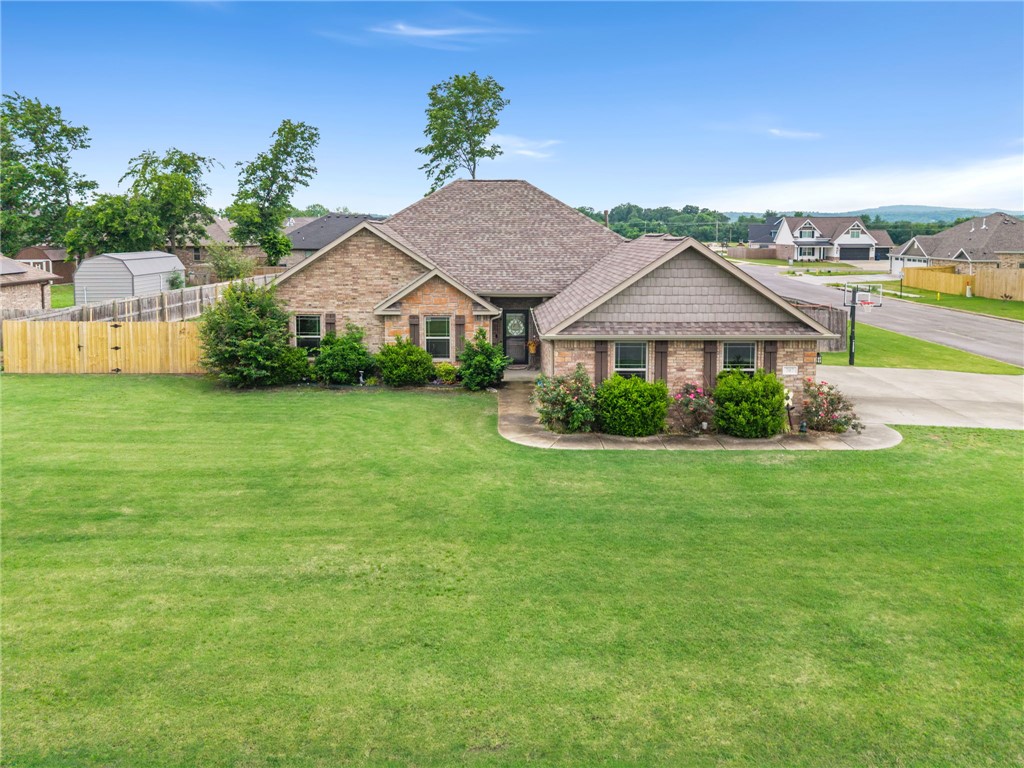 The one with the nearly half acre (0.47) corner lot, with a side set 3 car garage. This home has so many features, it's impossible to describe them all, but let's try! The covered back patio features a gas fireplace and tv hook ups and home is within walking distance to the Aquatic Center, schools, shopping, and more! The exterior of the home is beautifully landscaped with a 3 car side set garage. 4 bedrooms all with walk in closets! A large, and inviting living room with a gas fireplace adjacent to an impressive kitchen with modern cabinets, granite counters, and a breakfast bar. A split floorplan allows the primary to feel like a luxurious getaway - large room, 2 walk in closets, and bathroom featuring a double vanity, standing shower, and separate garden tub. A generous laundry room with ample storage and shelving is located conveniently near the garage entrance and a perfect drop zone. But let's not forget the backyard! This home is located on nearly a half acre lot with a full fenced backyard. A MUST SEE!!