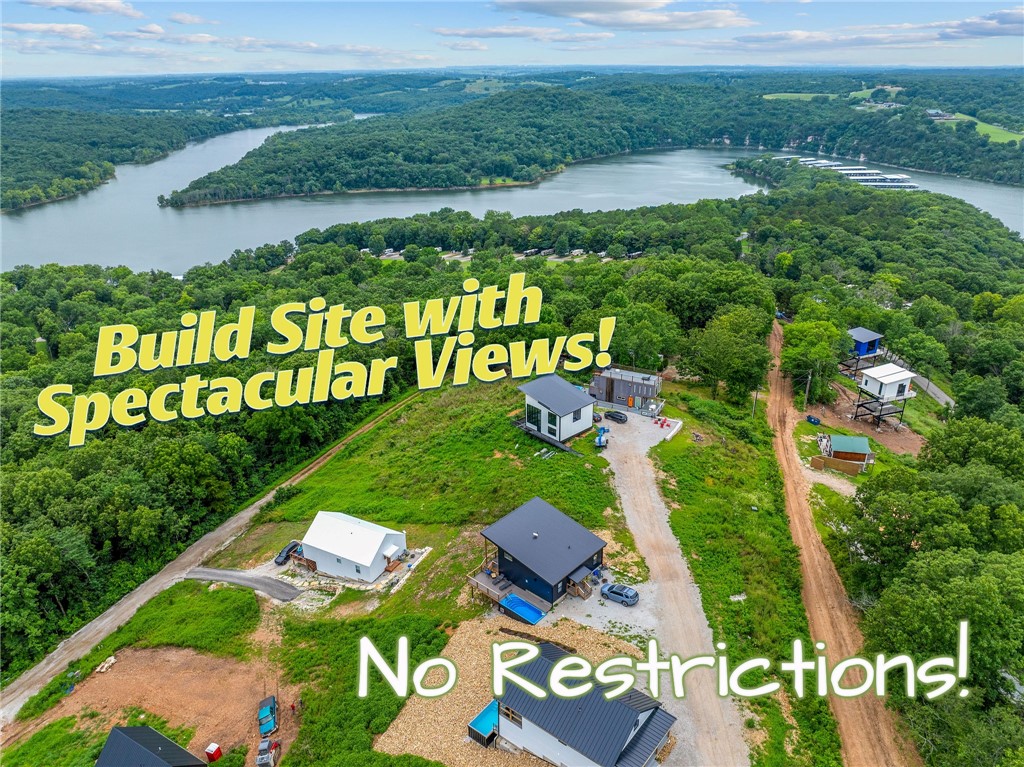 Million-dollar views without the million-dollar price tag! Exceptional opportunity to own a prime nightly rental build site with spectacular lake and panoramic views in one of the area's most successful vacation rental destinations. With no HOA and no use restrictions, this property offers the flexibility investors and developers are looking for. Electricity and rural water are available at the site, making it ready for your next successful cabin, vacation rental, or custom retreat. Ideally located less than a mile from Cricket Creek Marina and just 10 minutes from Big Cedar Lodge, Top of the Rock, and Thunder Ridge Nature Arena, this location attracts visitors year-round. Branson's shopping, dining, and entertainment are only 20 minutes away. Whether you're building a luxury vacation rental or a personal getaway, this rare view property combines outstanding rental potential, unmatched scenery, and a premier location.