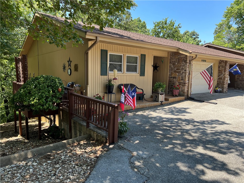 At $141 a sq. ft., you won't find a nicer townhome in Bella Vista! Throw in a new HVAC system, numerous upgrades, adjacent to beautiful Lake Windsor and this is one of the greatest values in town! Centrally located with convenient access to trails, golf, tennis, BV Rec Center, pools, shopping and dining. Open floor plan with main level primary bed/bath, wood floors, fireplace and home library. 2 sunrooms with wooded views and private deck are perfect for relaxing or entertaining. Low maintenance, permanent siding, newer architectural roof (2020) and Pella double hung windows provide peace of mind. Grounds maintenance services provided by the Bella Vista Townhouse Assn. including mowing, weed eating, leaf cleanup, weed control and trimming bushes and shrubs offer the amenity-rich, care-free lifestyle you long for! Ample storage throughout including an oversized single-car garage with workshop area. Dishwasher and garbage disposal recently replaced. Refrigerator, upright freezer, washer and dryer all convey!