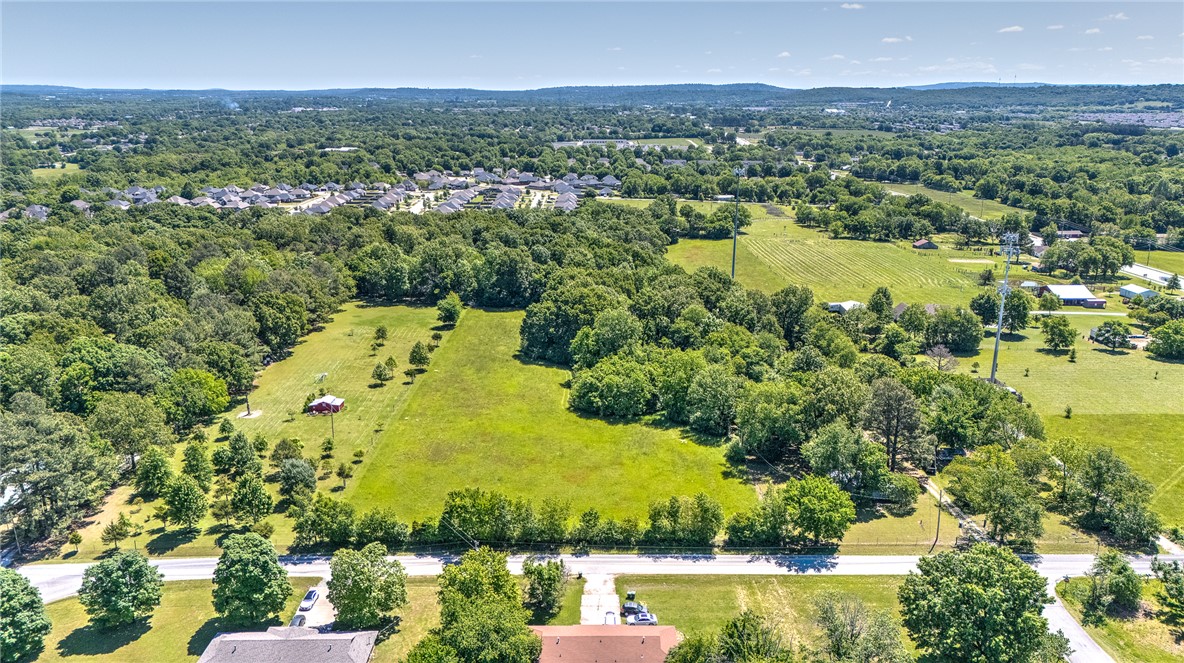 Just outside Fayetteville, Arkansas, this remarkable 10-acre property combines privacy, natural beauty, and convenience—only ten minutes from the University of Arkansas. A rare mix of open acreage and mature woods provides multiple build sites to suit your vision, from a custom estate home to a family compound or small development.

The buildable areas offer cleared and level terrain, while the gently rolling wooded section at the back features towering hardwoods that create a serene, secluded backdrop and space for recreation. With utilities available at the street and abundant wildlife, the setting feels beautifully remote yet remains close to all the amenities and energy of Fayetteville.

Experience the best of both worlds—peaceful countryside living on the edge of the city. Call today for your private tour and discover all that this exceptional property has to offer.