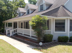Close to town and still private.  Updates since 2008:  Quality light grey siding, two HVAC heat pumps, 50 gallon hot water heater, walk-in tub in the master BA, hardwood floors downstairs, vinyl planks in the kitchen and laundry room, back deck expanded and a screened porch added, driveway re-surfaced this year.  There is a storm shelter on the property and the main electric box is wired to accept a backup generator.