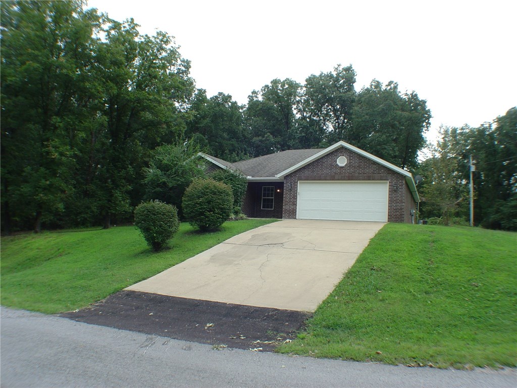 Neat and clean home with split floor plan. Gas log fireplace in living room. Newer wood laminate flooring. Large corner lot, fairly level.