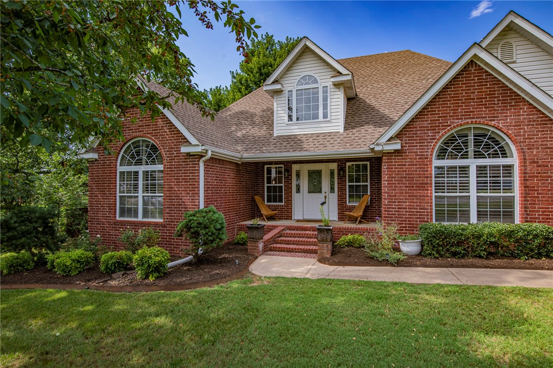 Stunning cathedral ceilings through the entry into the living room, beautiful hardwood floors, and lots of light give this house a fantastic feel right away. This 4 bedroom 2.5 bath Fayetteville stunner is well maintained and updated. Incredible built-in bookshelves draw the eye, and the sunroom that's open to the living room and kitchen provides that extra bit of space everyone is looking for. Tons of custom cabinets with pullout shelves in the eat-in kitchen, and a low bar for 4 that's open to the living room. The wainscoted formal dining provides a pop of color, and the very Southern plantation shutters provide luxurious light control. It's a truly split floor plan with 2 bedrooms and a hall bath on one side of the house and a secluded primary suite on the other. Dual vanities, jetted tub and glass shower, plus a large walk-in closet in the ensuite bath. Dedicated laundry room with deep sink, cabinets and counter space.  The upstairs bedroom has a half bath and could double as a bonus room or second living area.