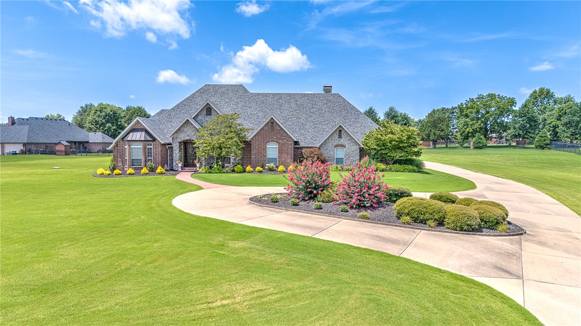 A rare find in the desirable Stonebriar community and Bentonville School District, this one-level home offers an ideal interior layout paired with exceptional year-round outdoor living on nearly 1.5 acres. An impressive outdoor retreat awaits - complete with a fully fenced, heated in-ground pool, an outdoor kitchen and lounge, and separate covered cabana. Within, you’ll find two separate living areas, offering both formal and casual spaces for gathering. Rich wood cabinetry and thoughtfully integrated built-ins provide ample storage throughout. The home features four spacious bedrooms, including two private suites, while two additional bedrooms are connected by a convenient Jack-and-Jill bathroom. A dedicated office with custom built-ins and desk offers a polished workspace. With only two owners, this property has been meticulously maintained. Complete with a four-car garage plus workshop and amenities throughout, this beautifully updated home delivers exceptional functionality. Schedule your tour today!