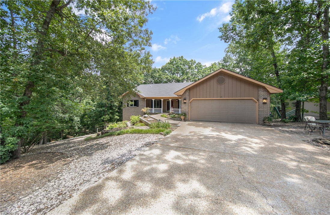 Come see this gorgeous home that has fresh paint, newer stove and microwave, new hardware and lights all with sitting right beside the Tunnel Vision trail.  The gorgeous sunroom off the back features a beautiful view of the woods and trail.  There is a golf cart negotiable as well with a brand new battery.  Plenty of storage underneath as well.