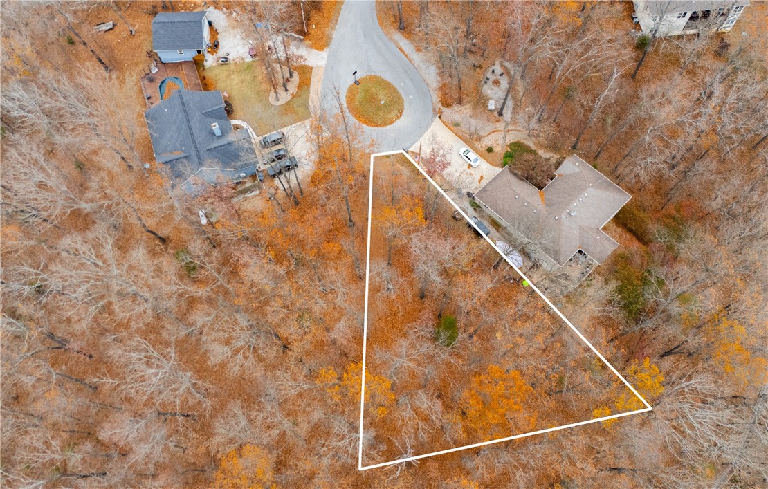 This buildable lot offers the perfect blend of privacy and convenience, situated at the end of a cul-de-sac with the Back 40 trail running right behind it. You'll also have direct access to the Snowbird trailhead, making it an ideal spot for outdoor enthusiasts. With sewer access at the street and a survey available, this lot is ready to go. Plus, there's potential for scenic views of the McNelly Rd valley. Located in East Bella Vista, you're just a short drive from Metfield golf, Blowing Springs Park, and the many amenities offered by the Bella Vista POA, including bike trails, golf courses, lakes, and gyms. The adjoining lot is also available for purchase (MLS # 1293191) for even more space!