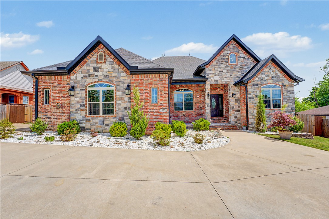 Beautiful custom-built 2020 modern home designed for comfortable family living, featuring soaring cathedral ceilings, abundant natural light, and upscale finishes throughout. The open-concept layout showcases custom cabinetry, granite countertops, a gas range, LED lighting, and smart home sensors. Enjoy relaxing front and back porches with durable epoxy flooring, plus insulated storage, a tankless water heater, and security cameras for added convenience and peace of mind. Ideally located near walking trails, shopping, schools, a church, and a hospital. A rare blend of style, comfort, and location! Refrigerator, washer, dryer, and gym equipment do not convey.