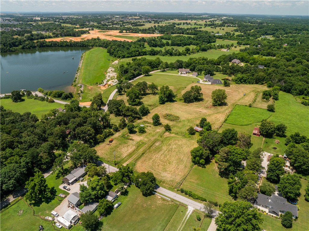 Rare opportunity in Elm Springs-10 scenic acres with open views of Elmdale Lake. Gently rolling and picturesque, this property is ideal for a private luxury estate or a builder's showcase project. Peaceful setting with endless potential.