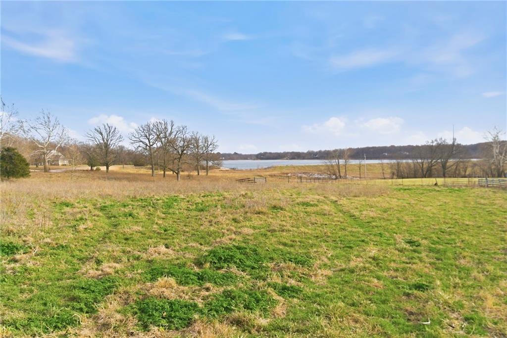 Rare opportunity in Elm Springs-10 scenic acres with open views of Elmdale Lake. Gently rolling and picturesque, this property is ideal for a private luxury estate or a builder's showcase project. Peaceful setting with endless potential.