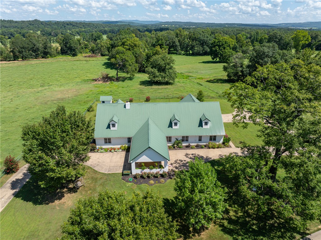 Welcome to your dream country retreat just minutes from the Ozark National Forest! This beautifully renovated 5,636 sq ft farmhouse sits on 28.92 fenced acres, offering modern comfort, functionality, and wide-open recreation. Inside features 5 bedrooms, 4.5 bathrooms, two office spaces, and an upstairs bonus room that could be converted into two additional bedrooms.

Ideal for livestock or hobby farming, the property includes fenced pasture and multiple outbuildings. The open-bay warehouse includes a separate apartment for guests, rental income, or multigenerational living. The barn offers horse stalls, a tack room, storage, and a three-car garage.

A natural gas lease with Black Hills Energy provides free natural gas to the home. White Oak Creek borders the north boundary, offering private fishing, swimming, and kayaking access.

Whether for a farm, equestrian estate, or peaceful country living, this property offers endless opportunity. Schedule your private showing today!
