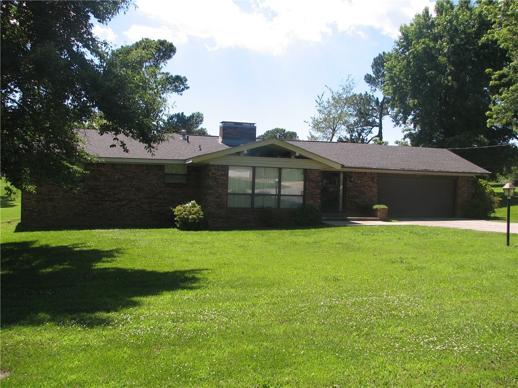 Nice single level home on the east side of Fayetteville, interior has a contemporary flare with room partitions opened above to expose the cathedral ceiling with beams, large brick fireplace with gas logs in the family room, extra big hall bath, small work shop off of the garage, and beautiful oversized lot with mature trees.  Lot is large enough to build a shop if desired.  There is a fenced off dog run and storage building in the backyard. To be sold AS-IS and without a Sellers Property Disclosure.