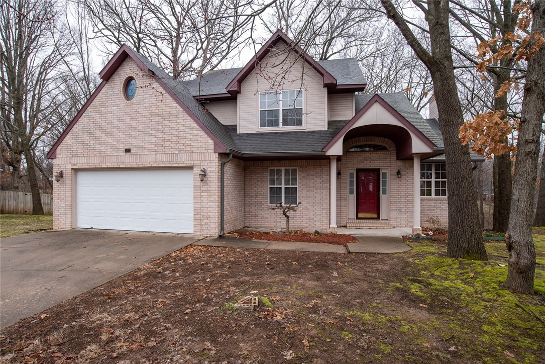 Not your average home! Look closely at this unique plan. Featuring oversized fireplace mantel, bridged stairway and huge kitchen! All bedrooms are on 2nd level. Use the front room for formal dining or office. All on a wooded, private lot on a cul-de-sac.