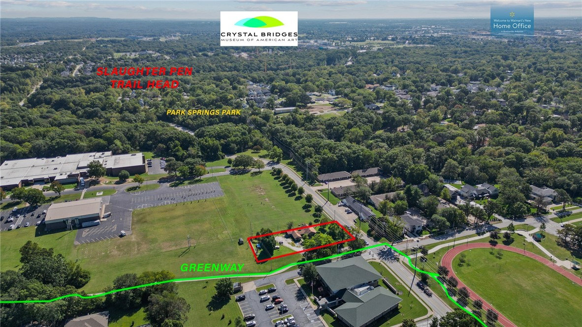 .47 lot with major development potential situated in close proximity/walkable distance to four schools, adjacent to paved Razorback Greenway biking/walking trails, a short ride/walk to Park Springs Park & mountain biking trails at the intersection of N.W. A Street & Tiger Blvd, & a 5 minute drive to Crystal Bridges Museum of American Art, The Amazeum, & Downtown Bentonville. Lot is zoned R-3,
Medium-High Density Multi-Family Residential. Recent survey available. Value is in land only.  Shed and chain link fence do not convey.