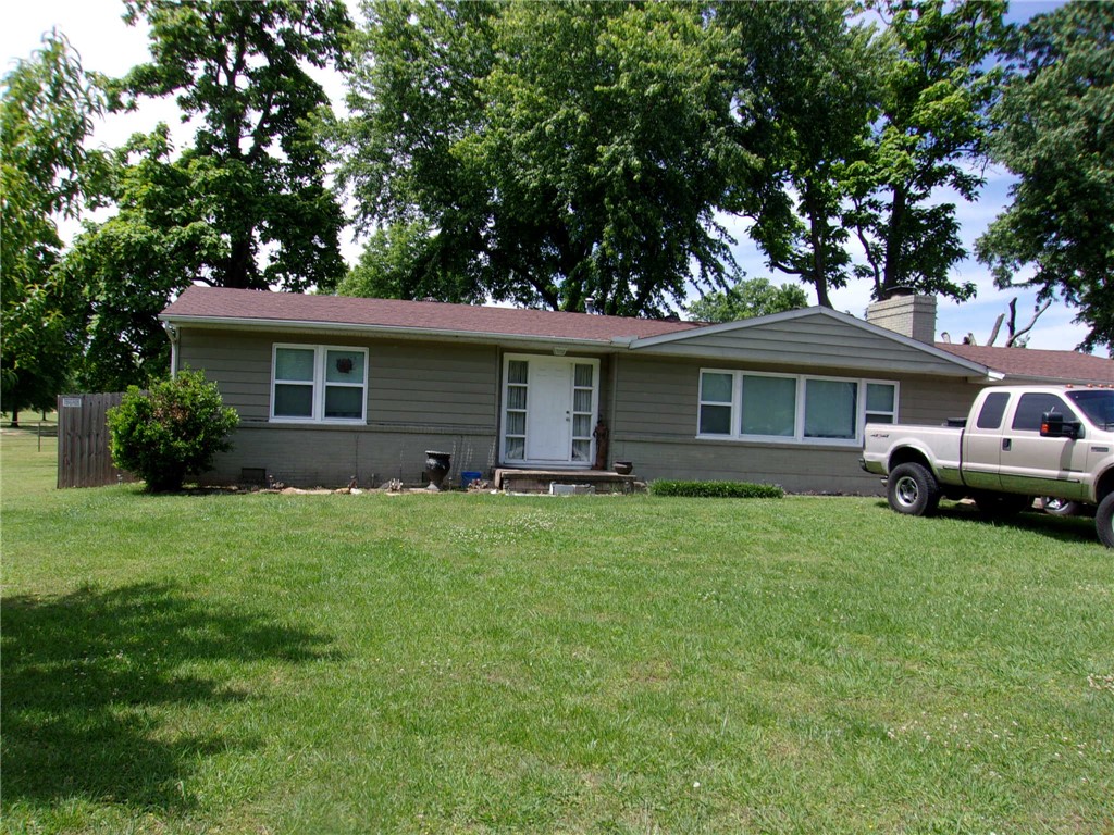 Ranch style home close to schools and shopping. This 2746 sqft. home has 3 bedroom with 2 full bath. Spacious room thru out this home with hard wood floors and ceramic tile. Large eat in kitchen to have family gatherings with plenty of room for a chef to cook up a feast. Living room has fireplace with hardwood flooring and windows facing toward front of home. This home also has a family room in back of home with lots of windows  over looking huge shaded back yard that has wood privacy fencing on three sides. There is a storage building that does convey. The garage is detached will  hold 2 vehicles with plenty of room for other things.   Gas central heat system was replaced in the last three years. This property has commercial potential.