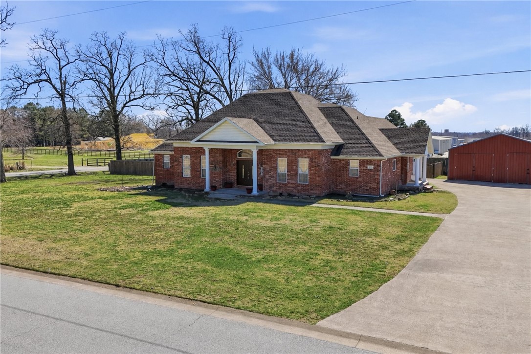 Beautifully updated home on nearly an acre in Lowell, just west of I-49! Seller is motivated and ready to work with buyers—bring your offer. This spacious home offers a flexible layout with granite countertops, fresh paint, a newer roof (2019), and hardwood and tile flooring throughout much of the main level. Enjoy three bedrooms and three full baths downstairs, along with multiple living and dining spaces perfect for entertaining or everyday living. Upstairs, a private suite with its own full bath creates the ideal setup for guests, a home office, or bonus retreat. Step outside to a covered patio overlooking the large backyard and enjoy the versatility of the impressive 30×30 workshop—perfect for hobbies, storage, or extra parking. Conveniently located near Bentonville, Rogers, and Fayetteville while still offering room to spread out and breathe.