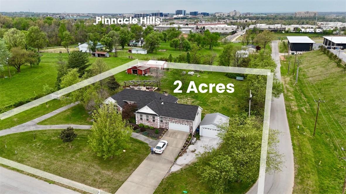 Prime 2-acre corner development opportunity in Rogers’ high-growth Pinnacle Hills corridor. Zoned T2 with Future Land Use designation of Urban Neighborhood (U-NH) per Rogers’ 2024 UDC — the city’s stated direction for mixed-use, walkable redevelopment on this corridor.
Corner parcel offers dual street frontage on the planned 30th Street pass-through, future street connectivity, and fast-track administrative approval potential for compliant UDC projects. 
Existing 2,780 SF home (3 bed / 2.5 bath, multiple living areas, plus an inground pool, mature trees, private setting) offers immediate use as a residence, premium rental, or interim holding asset while future plans dev.
Minutes from the Plaza at Pinnacle Hills (under construction), two incoming luxury hotels (Hilton & Marriott), the Bellview Entertainment District
Ideal for developers, investors, 1031 exchange buyers, or strategic land holders seeking a well-located parcel with flexibility and upside in one of NWA’s growth corridors.