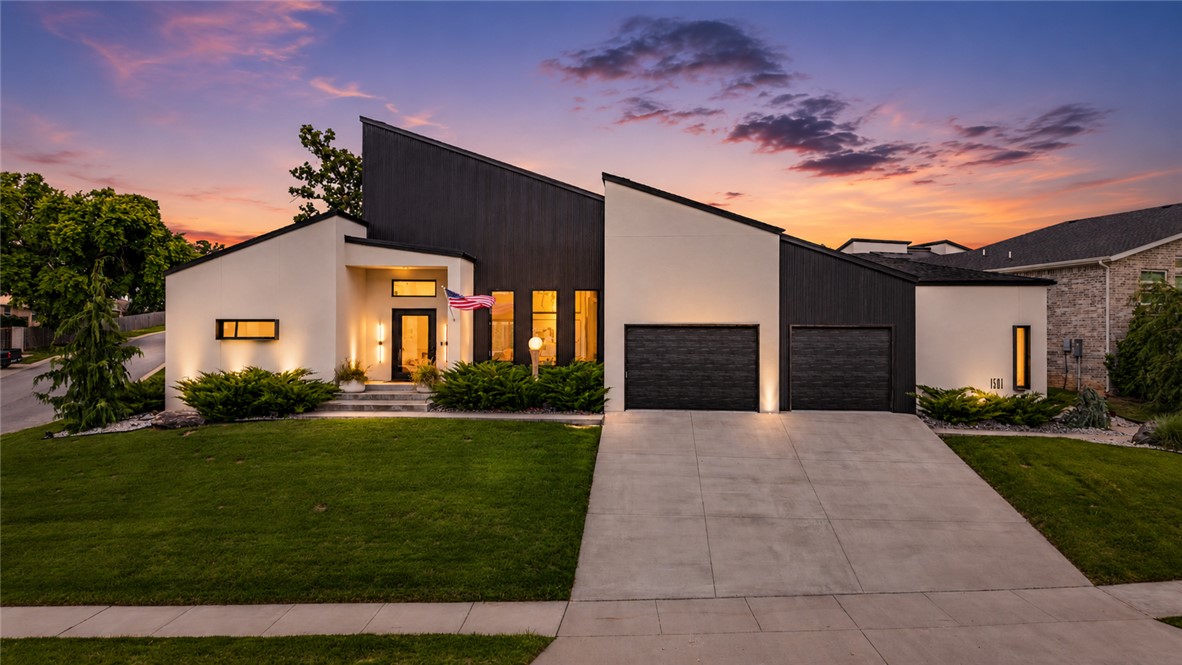 An architectural masterpiece celebrating fine art and sophisticated living. The 14' island with designer chandelier anchors the gourmet kitchen, featuring custom appliances, 6' refrigerator, & hidden pantry. Soaring 15' ceilings, custom cabinetry, & designer lighting flow seamlessly through accordion doors to the resort-style backyard. Spa-inspired primary suite showcases a double-headed shower, walk-in closet with integrated laundry & desk. Smart home technology includes zoned climate control with mini-splits, continuous hot water, direct internet for all TVs, 220 EV charging.  A dedicated fitness room, flex room with exterior access and dog door, dual laundries, & oversized epoxy garage with sink and built-ins. The resort-ready backyard includes a pool, a wired patio for sound and TV, custom landscaping, and a covered patio. Architectural details include gallery walls with spotlighting, casement windows, steel accent doors, pivot entry, and polished concrete floors. In the prestigious gated Westridge community.