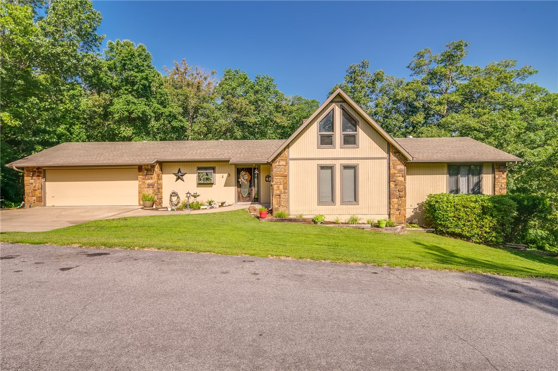 Beautiful home with tons of space in a quiet area! Large living room with soaring ceiling, rock wall wood-burning fireplace, carpet, accent lighting & lots of windows & skylight for great natural light. Kitchen has plenty of cabinet space & large eat-in area. Huge master bedroom with a balcony to sit out on. Master bath has large walk-in closet, deep jetted tub & separate walk-in shower. Upstairs has a great loft area overlooking the living room. Go downstairs to an additional living area (could be game room or man cave) complete with a bedroom & full bathroom. Washer/dryer connect on main & bottom levels. Huge walk-out workshop with a workbench & ample storage space. Sit out & relax in the enclosed sun room or out on the back deck with new decking & built-in bench seating taking in the peaceful & private surroundings. Huge backyard with a fenced-in area for animals. New shower valves, 16 seer AC 2 years ago, new paint. 2 car garage with additional space to park next to driveway. This won't last long!