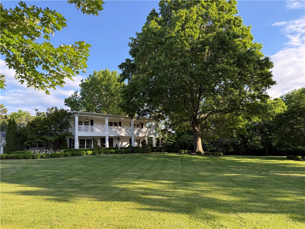 Centrally located in the heart of Fayetteville on 1.63 acres. Enjoy a serene setting overlooking mature trees and an English garden from a two-story sunporch.
The house is predominantly positioned on a sprawling lot within an established neighborhood.
Elmwood Drive is a direct connection to the Razorback Greenway trail system which gives you the added convenience of walking or biking to parks, schools and downtown Fayetteville.
Easily access I-49 and the University of Arkansas.
