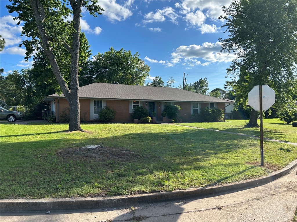 Move-In Ready! 4-bedroom, 2.5 bath. New roof 2024, new HVAC 2025, new water heater 2025, new engineered hickory flooring 2025, new gutters 2026. Fenced backyard, garden space, covered patio, storage building. 2 minutes to Rogers Aquatic Center. Corner lot.