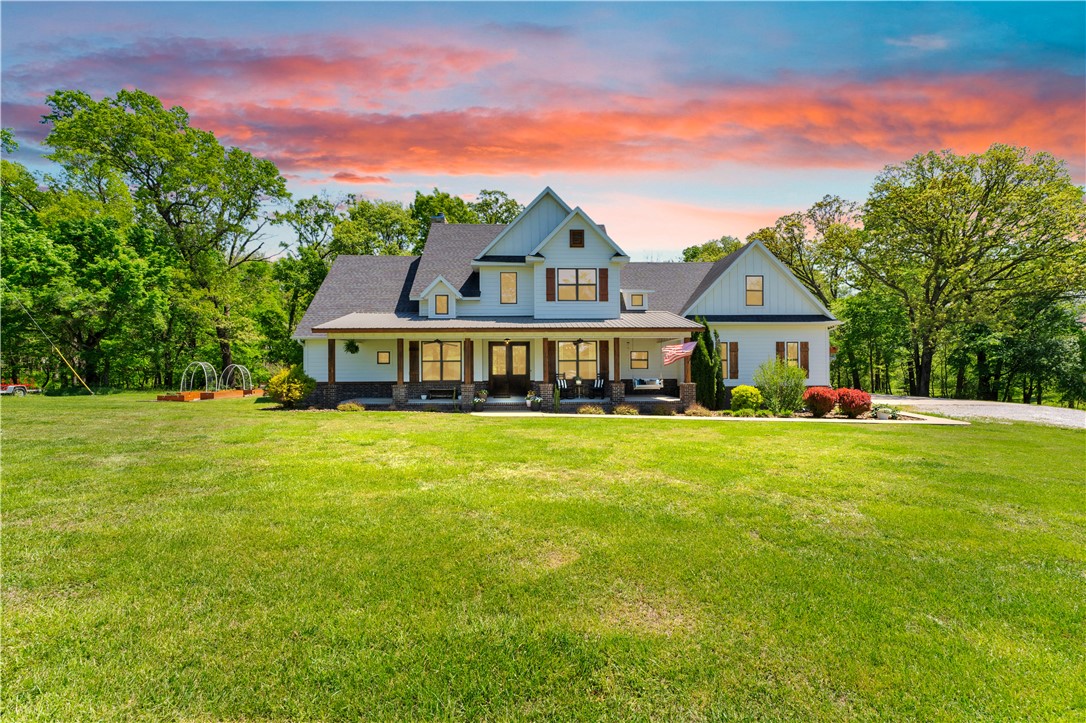 Some homes invite you in. This one invites you to slow down. Set on 5 expansive acres, mornings begin with soft light pouring through expansive windows as the sky shifts from golden to shades of pink and purple. In the primary suite, a picture window and window seat create the perfect place to sip coffee, read, and take in peaceful views of trees, green grass, and deer grazing nearby. Evenings gather around the warmth of the fireplace, where comfort and connection come naturally. The additional acreage offers space to breathe, added privacy, and room to create the lifestyle you’ve been dreaming of. All of this just minutes from downtown Bentonville, the Pinnacle area, local boutiques, and dining. Preferred lender offering up to 1% of loan amount in credits for qualified buyers. Also available on 3 acres. See alternate MLS listing 1343563.