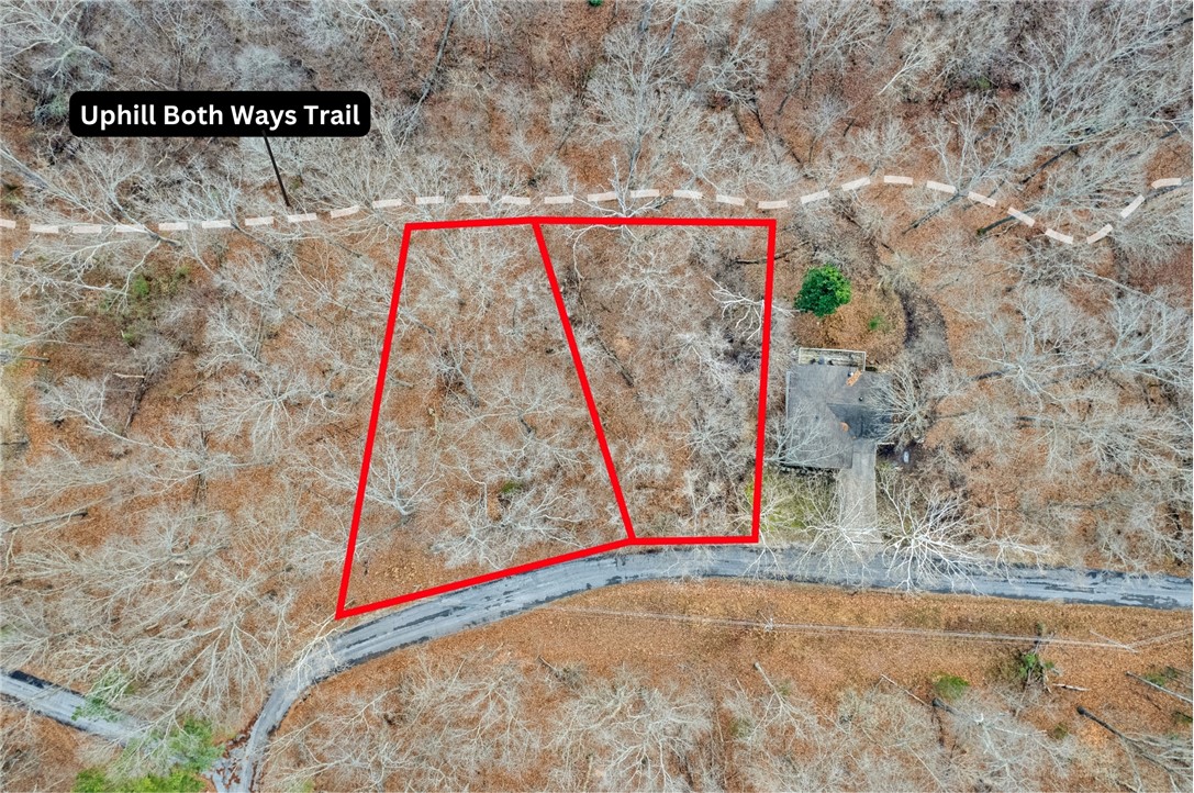 Rare trailside double lot in the heart of Bella Vista’s outdoor scene. Just off the Lago Vista + Uphill Both Ways junction, this prime homesite lets you ride straight into miles of flowing trail systems right from your door. Mornings on the bike, afternoons on Lake Windsor or Lake Avalon, and evenings dialing in your swing at Tanyard Creek or checking out the incoming Oz Trails Bike Park —this is everyday living built around movement, nature, and access to everything that makes Bella Vista one of NWA’s top outdoor destinations.