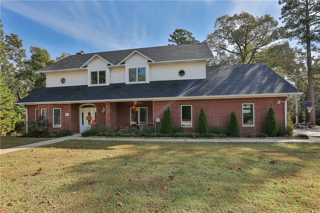 Over 1 acre to roam on! This has the perfect blend of wooded area, lush green grass, & space for kids to play. Short walk to the lake & still be in town in under 15 mins. Many upgrades like hand scraped wood floors, carpet, paint, kitchen cabinets. Large open kitchen opens to the two downstairs living areas featuring a wood burning fireplace. Master bedroom also has a fireplace and features a huge master closet & a great on-suite with large bath tub. Relax on the large covered deck. This won't last long!