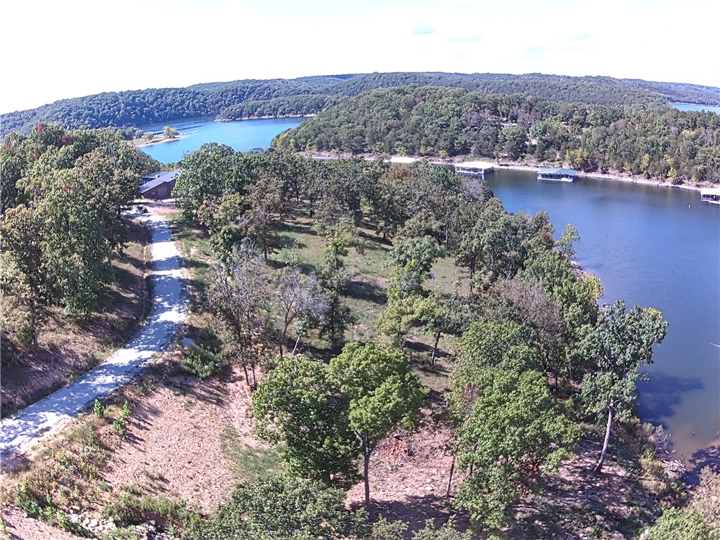 New lakeside community with large waterfront and lake view lots in gated community minutes from Hollister, Big Cedar Golf, Top of the Rock, and Thunder Ridge attractions.  Ready to build sites with water, power, and approved soils report for on site septic systems.  Unique opportunity to own to the water’s edge in community with CC&R protections and restrictions on short term rentals. Short 5 Min. drive to Cricket Creek Marina, remote service dock planned and pending Corp approval. Build your dream home in Arkansas on the quiet end of Table Rock Lake. Must see it to believe it.