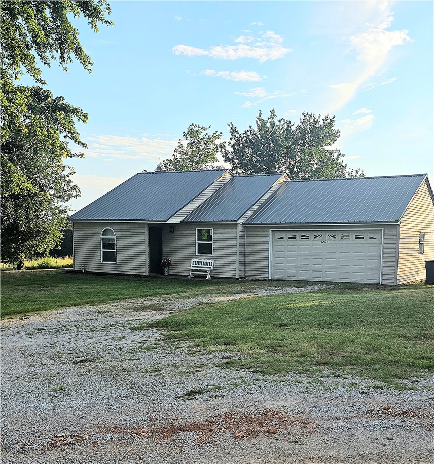 Enjoy peaceful country living with the convenience of being just minutes from town! Situated on 0.56 acres with end of road privacy, this charming 2-bedroom, 1-bath home offers beautiful views and a relaxing rural setting.  You'll love the low maintenance features of this home ranging from the metal roof to vinyl siding & it is built on a slab.  Recent improvements include a new metal roof (2025), new windows, and numerous additional updates making this home move-in ready & perfect for the first time homebuyer.  The oversized 2-car garage provides plenty of room for vehicles, storage & even boasts a corner garage workshop. Whether you're looking for your first home, a place to downsize or a peaceful retreat, this property offers the perfect blend of comfort, convenience, and country charm.  All #s are approx, age & square footage per assessor.   Agent owned.