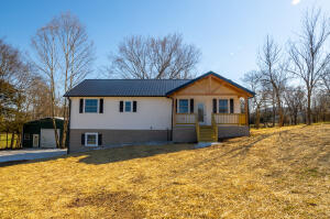5 bed/ 3 bath all electric energy efficient home on one acre.  Country setting yet close to town.  Enjoy morning coffee on front porch and afternoon sun on back deck. Rock and wood exterior with metal roof.  Main level features open living, dining kitchen area with large pantry. All new stainless appliances. Master bedroom has huge walk-in closet and spacious bath.  Main floor also has second bedroom and bath. Wide hallway and doors could be handicap accessible with few modifications.  Full finished basement features 3 more bedrooms, bath, sitting room plus family room that has water and electric to add second kitchen. Ceiling fans throughout the house.  Also 30'x50' shop with concrete floor, overhead door and wired for electricity.