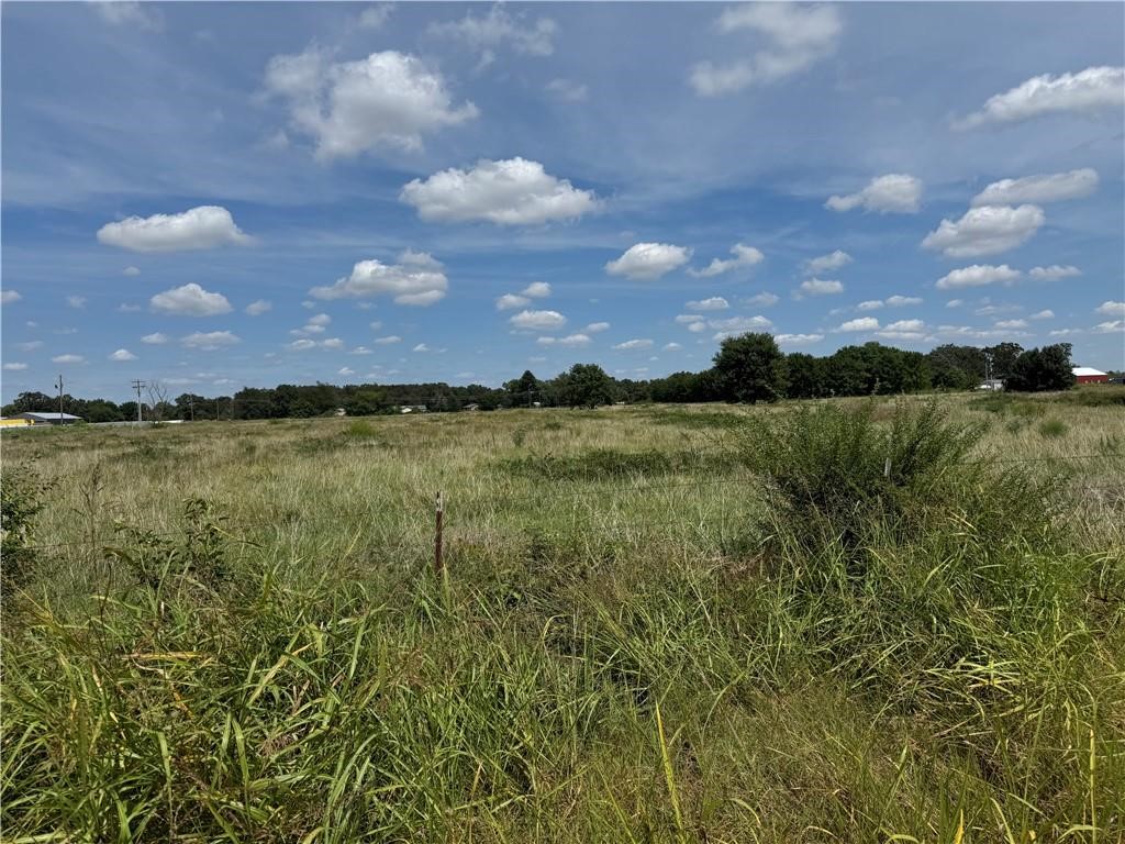 6 Acres m/l Industrial Land – Prime Location Near Highway 59. Unlock the potential of this 6 acre m/l tract of flat, open land ideally positioned for industrial or commercial development. Located just seconds from Arkansas Highway 59 and situated along Old Highway 59, this property offers unmatched accessibility and visibility. •    Zoning: Industrial – ready for a wide range of business uses •    Topography: Level and open, minimizing site prep costs •    Location: Seconds from Highway 59 with easy access to major routes •  Whether you’re seeking a site for manufacturing, logistics, or investment, this property delivers the perfect combination of strategic location, size, and development flexibility. Don’t miss this rare opportunity to secure a large industrial-zoned parcel in a high-demand corridor. Owner/agent property. See also MLS# 1320178, 1326202, 1326206 for more options