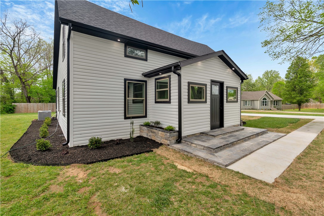Located in desirable North Fayetteville/Johnson, this completely remodeled home at 5808 S. Cardwell Rd blends modern style with major system upgrades for true move-in-ready living. The thoughtfully updated kitchen features granite countertops, stainless steel appliances, a gas range, under-cabinet lighting, and a spacious island with a built-in coffee bar—perfect for entertaining or everyday living. The functional floor plan offers two upstairs bedrooms, each with private en-suite bathrooms and walk-in closets, while the downstairs primary suite provides a relaxing retreat with dual vanities, updated tile finishes, and a large walk-in closet. Throughout the home, you’ll find luxury flooring, LED lighting, lighted mirrors, and remote-controlled ceiling fans that add both comfort and style. Located on an oversized lot of almost half an acre, extensive improvements include a new HVAC system, roof, electrical wiring, plumbing lines, and windows, offering peace of mind for years to come. Outside, enjoy deck lighting.