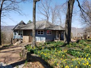 Great 3BR 2BA home on 18.85 m/l acres near the Little Buffalo River in Murray area of Parthenon AR.  Winter views, shop building with concrete floor and solar panels make this home perfect for full-time living but could also make a terrific get-away retreat cabin!  Unique semi-octagon living room with picture windows to fully appreciate the winter-view, custom leather couch that fits this will convey.  Some of the other furnishings are negotiable.  Cool grilling area near rear deck, inlaid brick and rock work abound, pet door, office space, storm shelter area in the basement, solar system is a PV system power 4.56kWp and it generates more power than is used so the only electric bill is the monthly minimum.