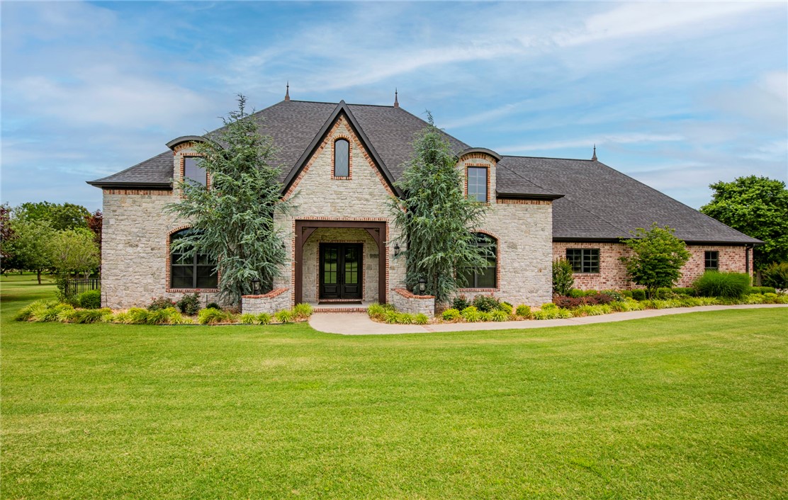 Beautiful custom home nestled back on a tree canopied 7.22 acre landscape. Offers a split floor plan with beautifully designed finishes, large living and entertaining space, wood-beamed ceilings and brick accents throughout, formal dining with wet bar, large master suite complete with his/her vanities, and an oversized utility room. Large, fully fenced backyard complete with a covered patio, built-in outdoor grill, and double-sided fireplace. Oversized garage with built-ins and wash sink. The house was custom built in 2014 by David Verucchi of Verucchi Custom Homes and fully operates on a geothermal heating & cooling system. Also includes a back-up generator, security system, and storm shelter. The property features a 2,400 sqft metal shop building with 3 overhead doors to accommodate an RV. Direct access to Little Wildcat Creek. Conveniently located with easy access to HWY 112 and I-49, yet perfectly situated to enjoy the private and tranquil surroundings this property offers. Don’t pass this one up!