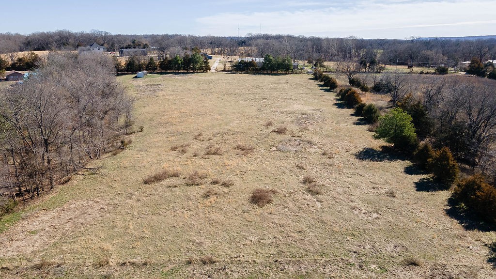 Come see your future slice of country life on this beautiful and varied 5 acres, less than 15 minutes from downtown Rogers.  Open, level areas for your home, barns, and/or shop. A small wet weather creek running through a corner of this property.  Fully fenced for your horses or other livestock.  Electric and water at road.  Whether this is the dream farm for you and yours, space enough for your home AND your business, or to develop in so many other ways, do not pass up an opportunity to own this great 5 acre parcel. Additional listing with house and 12.4 acres at MLS# 126162, and seller is willing to split off more acreage without the existing buildings to add to this 5 acre parcel. So many opportunities to accommodate your future plans. No owner financing.