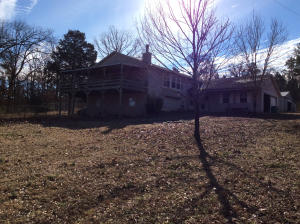 Large family home features a split level floor plan. Great room has built-ins & fireplace, large kitchen, master bedroom with Jacuzzi tub a second bed & bath on top floor. Down stairs features a built in computer station, a large family room 2 bedrooms and a full bath along with unfinished basement space. Large deck with a view off the great room. 2 workshops with electricity, one shop has bathroo