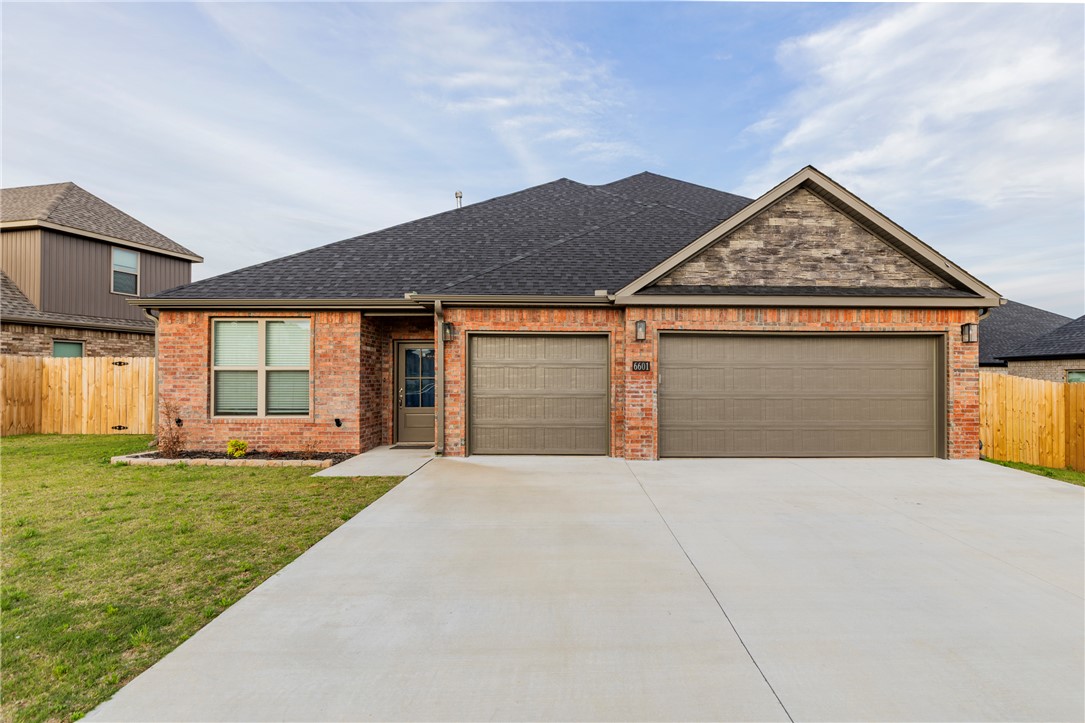 Welcome to 6601 Acacia St, a beautifully designed West-facing 2025-built home nestled in a brand-new Bentonville subdivision. This home is one of the few homes in the subdivision with a 3 car garage! This home offers the perfect blend of modern luxury & everyday functionality, all just minutes from Vaughn Elementary, XNA airport, grocery stores, gas stations, & more! The kitchen features quartz countertops, custom cabinetry with a built-in wine rack, & a large kitchen island. The living area boasts a cozy gas fireplace. The master suite is a true retreat, with a spa-like bathroom featuring a soaker tub built into the walk-in shower, creating a seamless & luxurious experience. Every detail in this home has been thoughtfully designed to create a comfortable, stylish living space. Fence, blinds, & gutters included!