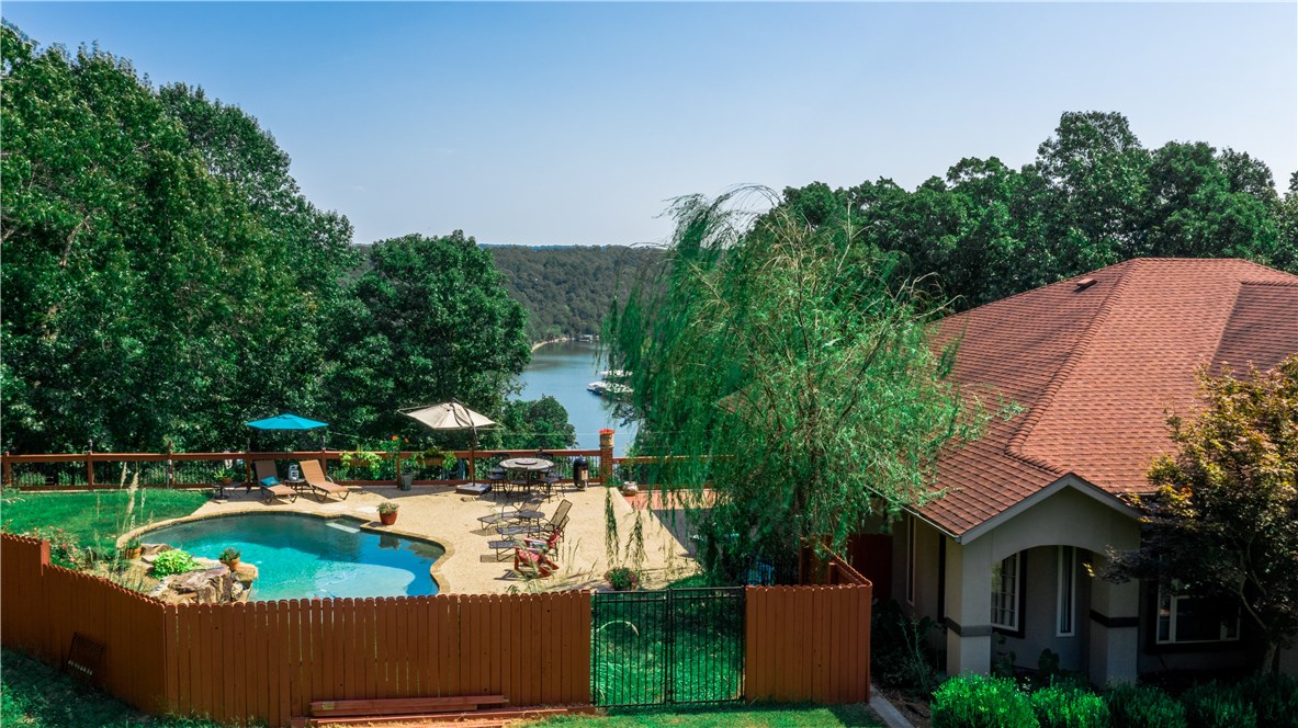 Talk about a Lake View! Walk in the front door and look out the floor to ceiling windows of Beaver Lake. Enjoy your family and friends in any of the three living spaces upstairs or in the full basement. Then go out to the pool for more family time. Don't forget about the workshop that is detached on these five acres. Come check it out. Hickory Creek is just 10 minutes away to Frisco Springs. Shop apartment 14x30. Shope without apartment 25x30 with loft.