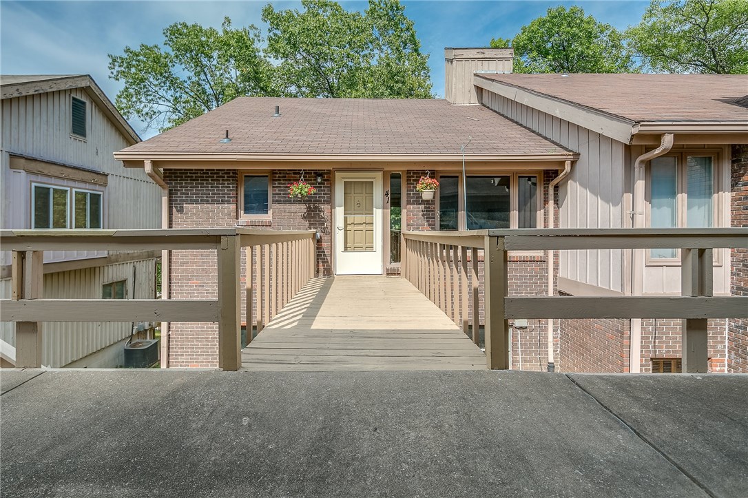 Great townhouse in Bella Vista. Living area with nice wood laminate flooring & nice view with stairs leading to lower level. Kitchen with gas-top stove & refrigerator conveys. Carpet in bedrooms. Sliding doors to the upper level deck and lower level deck to sit out and relax & has steps leading to the ground. Opportunity is right here with this property. Enjoy living here or gaining some rental income.