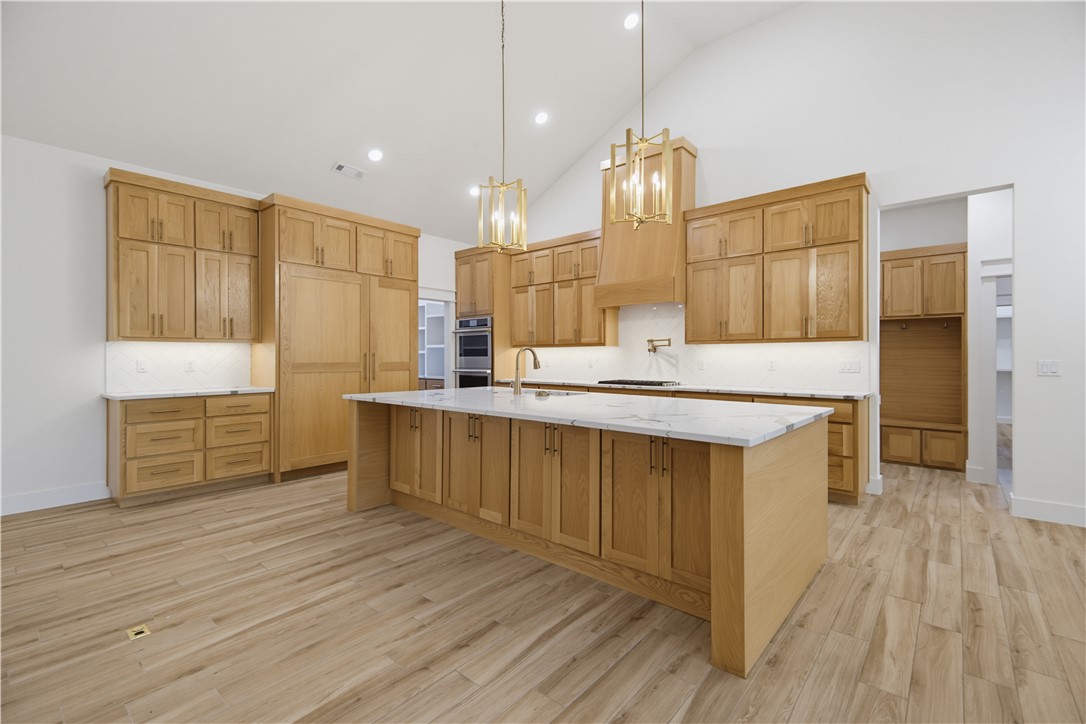 This home checks boxes you didn't know you had.  On 1.1 private, cedar-fenced acres in Timber Ridge Estates, this 2024 custom estate delivers 5,000 SF of proof: 10' ceilings, 14' entry, and vaulted living wrapped white oak built-ins.
The kitchen makes the case: 10'x5' quartz island, JennAir paneled fridge/freezer, double ovens, 6-burner gas cooktop, pot filler, and a 10'x8' sliding glass wall to the covered deck. The boxes keep coming: private theater room. Main-level office. Huge bonus room. Bottom-level in-law suite with exterior entry.
The primary bath features dual rain heads, 12 body sprayers, jetted 6'x4' tub with waterfalls and audio, plus a white oak closet with direct laundry access.
The boxes you'll feel every month: 2x6 walls, R-42 insulation, tankless recirculating water heater, fiber internet, smart-home features, and an epoxy-floored 3-car garage with 15'4" ceilings.  Custom construction. Private acreage. Zero compromises. Come check every box including the ones you didn't know you had.