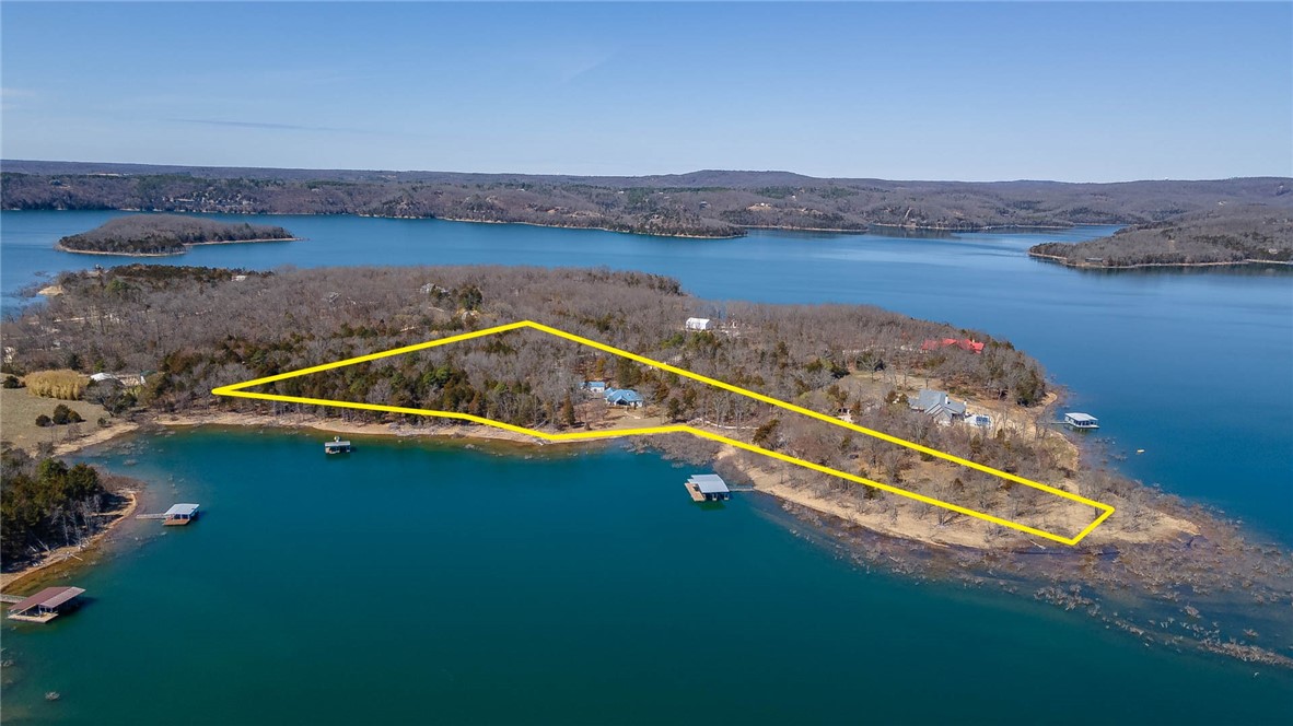 Amazing Opportunity to own a slice of paradise with over 700 feet of shoreline on Beaver Lake!  This listing includes 3 parcels of land totaling 8.07 acres, a 1,957 sq ft home, 1,500 sq ft shop, and a private boat dock with 4 slips and swim deck!  The home offers 3 bedrooms, 2 baths, open eat in kitchen to living, separate laundry, gorgeous outdoor covered deck, and a 3 car garage.  It is furnished and move in ready!!!   The land is flat and offers a grassy walk to the water.  The other 2 parcels of land are easily buildable OR just enjoy the privacy and acreage to yourself.  The property sits across from Rocky Branch Marina.