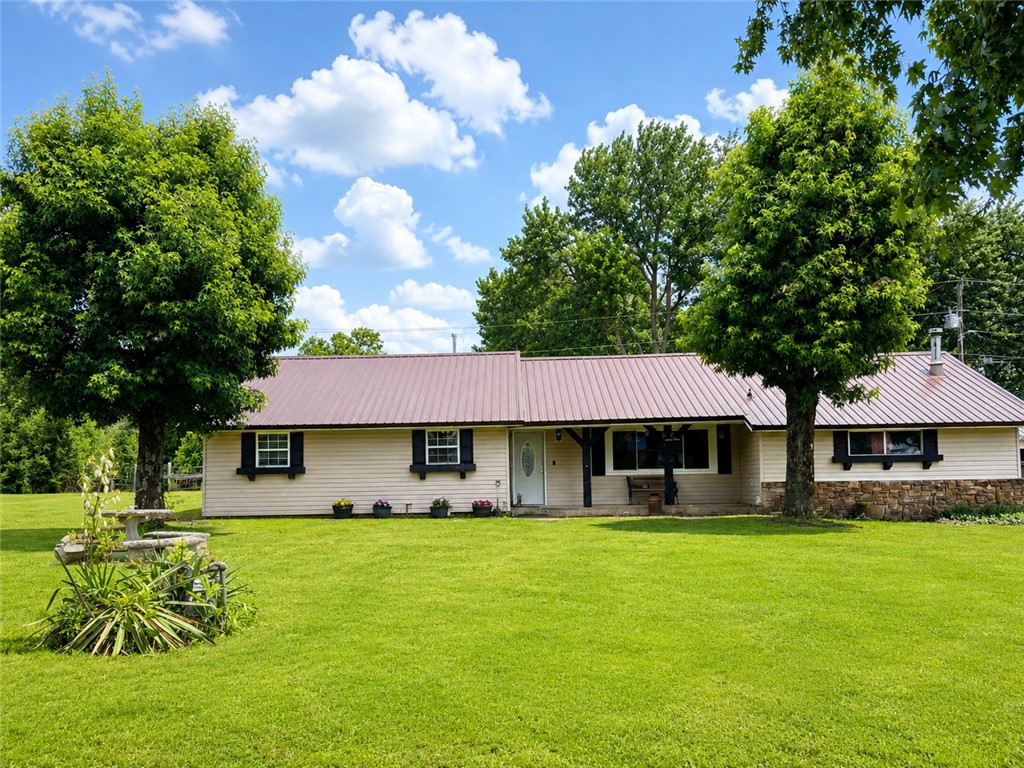 This move-in-ready home offers a seamless transition for its next owners and reflects years of pride of ownership and care. Situated on an expansive 4.0+/- acres and has a charming front porch and peaceful outdoor living spaces, including a pool perfect for enjoying the surrounding countryside views.

The home features 3 bed, 2 full baths and a heated and cooled enclosed patio that provides additional year-round living space. You will find a spacious 3-car garage/workshop, a barn, and a storage shed offering endless possibilities for hobbies, equipment, animals, or future expansion.
Conveniently located near shopping, dining, and interstate access, this charming Springdale property combines the comfort of country living with the convenience of being close to town. Whether you're looking for room to grow, space to work, or simply a peaceful place to call home, this well-maintained property delivers exceptional value and versatility.