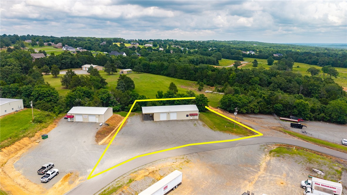 Versatile Commercial Property w/ Living Quarters & Shop Space – Prime Location. Conveniently located off Highway 65 in Greenbrier, this 3,200 +/- sft commercial building offers the perfect combination of workspace and comfortable living quarters. The 100'x40' building features 1,600 sft of centrally heated/cooled living space, 5 bedrooms, full kitchen, and laundry area—ideal for your business, employee housing, or office conversion. The remaining 1,600 sft of shop space is well-equipped for a variety of commercial uses, featuring 220-volt electrical service, wash sink, two 14-foot overhead doors, overhead lighting, and propane gas. Above the living quarters is additional decked storage space. Outside, the property includes an attached 20'x40' covered carport, for parking or workspace. Whether you're looking for a contractor's headquarters, automotive shop, warehouse, or a live/work opportunity, this versatile property is ready to meet your business needs, call for your private showing today!