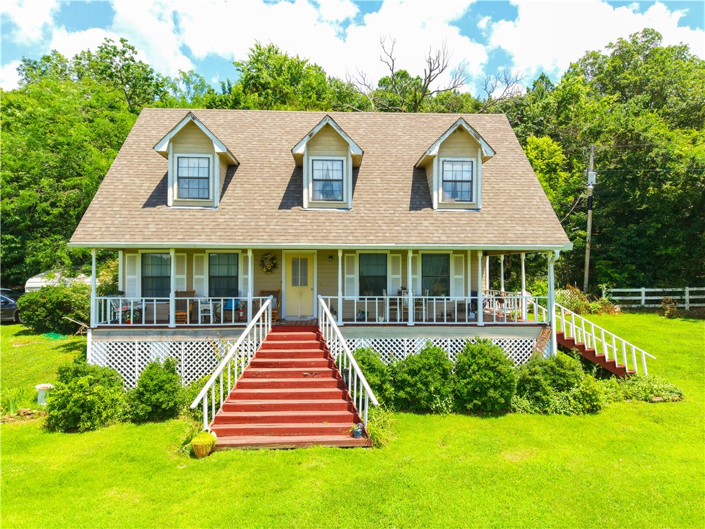 Welcome to your own slice of paradise! This beautiful 3-bedroom, 2-bath home offers 1,452 sq ft (per CH) and sits on an incredible 80 acres of breathtaking countryside. From the inviting front porch, enjoy panoramic views that stretch for miles, making it the perfect place to relax with your morning coffee or unwind after a long day. The property features a picturesque white picket fence, a gorgeous hay meadow, and a scenic pond, creating the ideal setting for country living. Outdoor enthusiasts will appreciate the excellent hunting opportunities and abundant wildlife that roam the property. With direct frontage along AR-59, accessibility is convenient while still offering the privacy and tranquility you've been searching for. Located just 30 minutes from Siloam Springs and 40 minutes from Fayetteville, this property combines peaceful rural living with easy access to shopping, dining, and amenities.