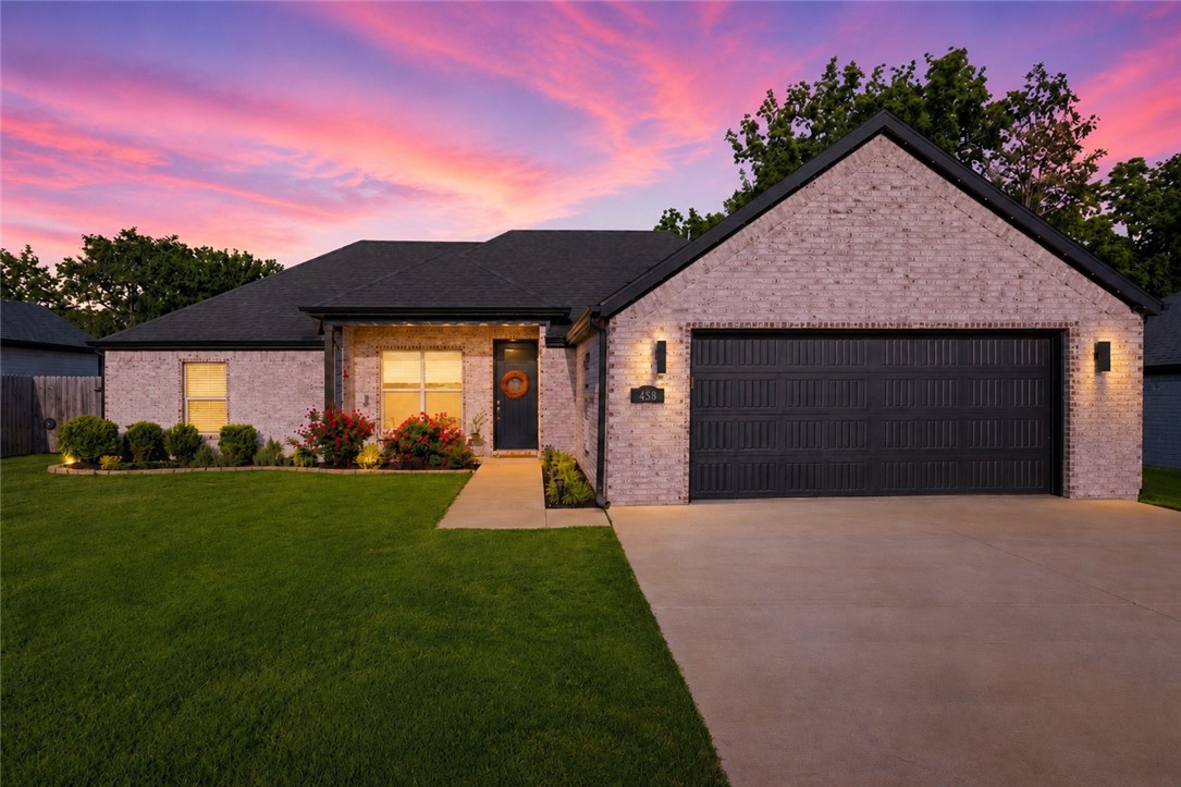 Tucked into the desirable Farmington/West Fayetteville area, this beautifully upgraded home offers the perfect blend of convenience and privacy, backing up to a peaceful wooded backdrop with a serene creek. Inside, thoughtful upgrades include an impressive 8-foot Craftsman front door, upgraded lighting package, beautiful cabinetry w/ soft-close hinges, & counter-to-ceiling backsplash in the spacious kitchen featuring an oversized island with microwave drawer, farmhouse sink &GE double ovens. The primary suite offers a spa-like feel with an upgraded walk-in shower and luxurious 6-foot soaking tub. Additional highlights include satin paint finishes, floor outlets in the living room, insulated garage door, full decking above the garage for extra storage, and an extra-wide driveway. Enjoy mornings on the expanded front porch or evenings overlooking the wooded scenery.  Minutes from Harps, Walmart Neighborhood Market, restaurants, schools, and Lake Wedington lake & trails. Seller offering a $6,000 buyer​​‌​​​​‌​‌​​​‌‌​​​‌‌‌​​‌​​‌‌​​​​ concession!