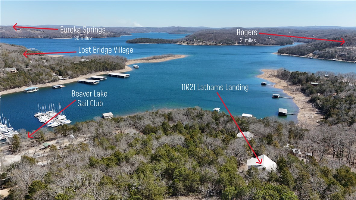 Welcome to a great opportunity to build out your ideal home on Beaver Lake. Situated on 1.12 acres, the house is set into the hillside to take advantage of the lake views. The large wood deck offers a comfortable place to enjoy the surroundings. Main level features an oversized living area with cathedral ceiling, kitchen and dining area, primary suite, and unfinished half bath. Upper level offers two large bedrooms with a shared full bath. Below the main level (Below Grade ADU) is a separate living space with its own kitchen, full bath, and two bunk rooms—well-suited for a rec room or added guest quarters. The home is partially finished and will require completion of items including two staircases and the primary and half baths. With a solid structure and a desirable location near the Beaver Lake Sailing Club, this property offers strong potential for the right buyer. Property is being sold as-is.