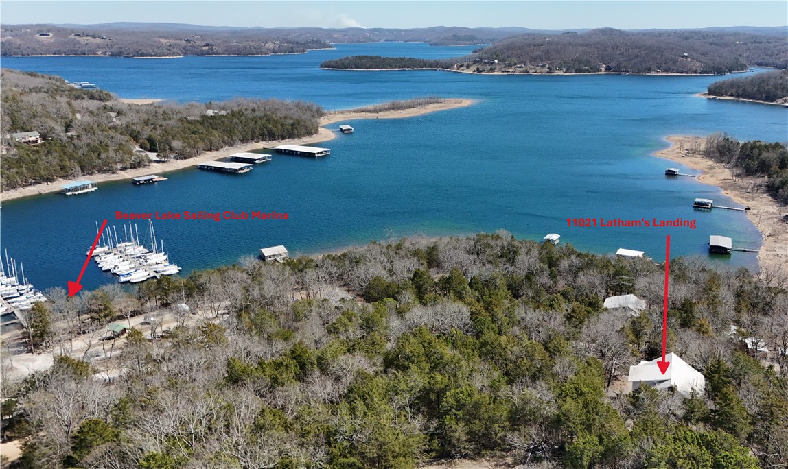 Welcome to a great opportunity to build out your ideal home on Beaver Lake. Situated on 1.12 acres, the house is set into the hillside to take advantage of the lake views. The large wood deck offers a comfortable place to enjoy the surroundings. Main level features an oversized living area with cathedral ceiling, kitchen and dining area, primary suite, and unfinished half bath. Upper level offers two large bedrooms with a shared full bath. Below the main level (Below Grade ADU) is a separate living space with its own kitchen, full bath, and two bunk rooms—well-suited for a rec room or added guest quarters. The home is partially finished and will require completion of items including two staircases and the primary and half baths. With a solid structure and a desirable location near the Beaver Lake Sailing Club, this property offers strong potential for the right buyer. Property is being sold as-is.