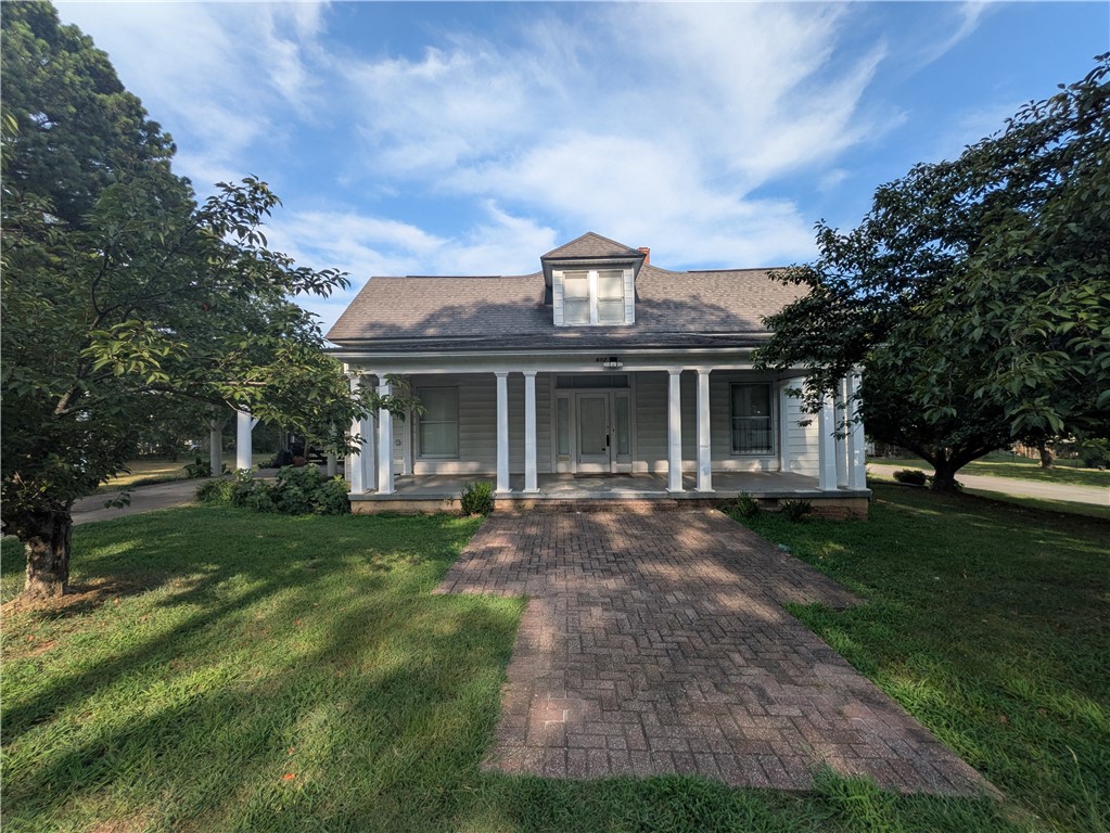 Timeless character and generous living spaces define this distinctive two-story Atkins home. Offering 3 bedrooms, including one upstairs, 2.5 bathrooms with one upstairs, plus formal living and dining areas, the home provides plenty of room for everyday living and entertaining. Hardwood floors, tall ceilings, abundant natural light, detailed trimwork, decorative fixtures, and an eye-catching staircase showcase its classic craftsmanship.

Additional upstairs space offers flexibility for an office, hobby room, playroom, or storage. The kitchen and baths retain vintage character with opportunities to update and personalize over time.

Outside, a broad covered porch, mature trees, expansive lawn, and covered parking add to the appeal. With operational HVAC, the home is move-in ready while offering abundant potential for future improvements. If you appreciate historic architecture, spacious rooms, and original details, 602 Avenue 2 NE deserves a closer look.