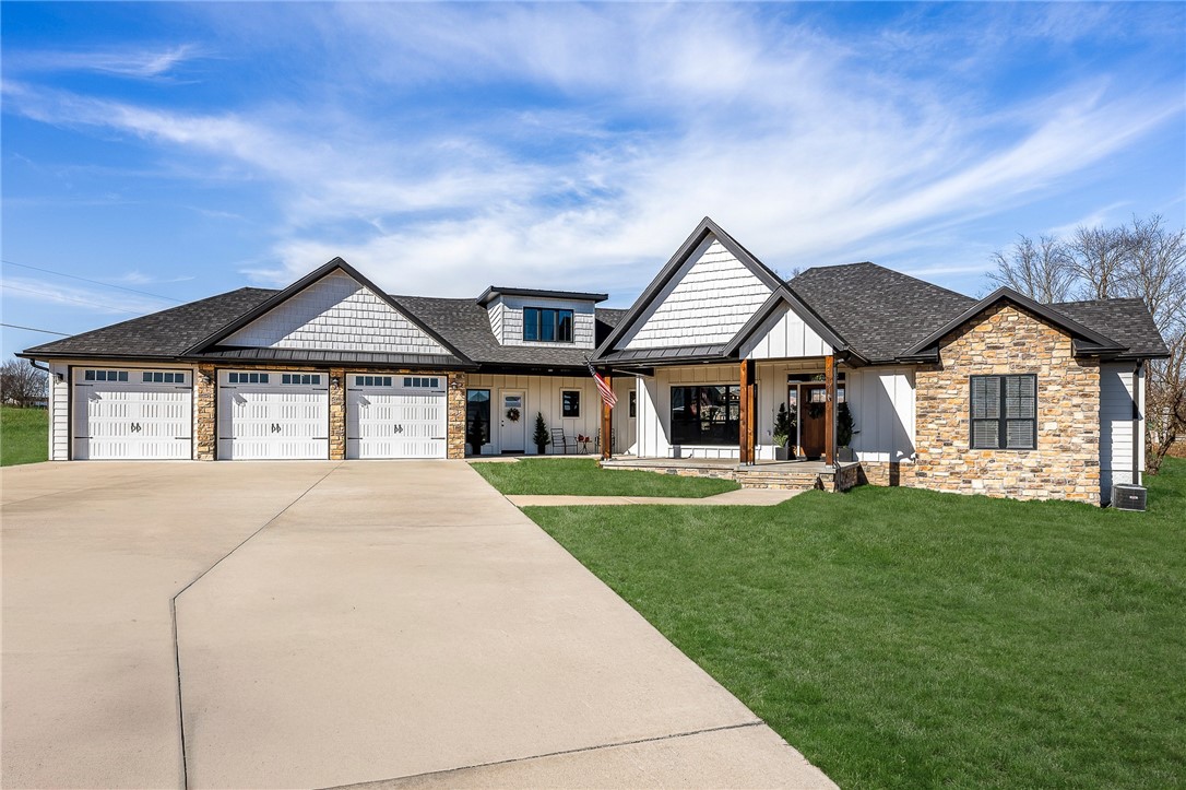 Beautiful custom-built home on 1.59 acres with beautiful mountain views. This home checks every box and delivers on every level- 5 bedroom, 4.5 baths, formal dining, bonus room and a three-car garage. The gourmet kitchen features quartz countertops, custom backsplash, large island with prep sink, a farmhouse sink, 5-burner gas cook top, double oven, a pot filler and hidden pantry.  The living room showcases vaulted shiplap ceilings with beams, built-in bookshelves, gas fireplace, and floor outlets. The primary suite includes trey ceilings with patio access, a spa-like bath with dual vanities, walk-in tiled shower, a custom closet with dresser and laundry hook-ups.  2-bedrooms with full baths and walk-in closets on the main level. 2-upstairs bedrooms, full bath and bonus room with bar. Luxury vinyl plank flooring, high ceilings, LED lighting 3 HVAC units, large laundry room with ample storage and 2 covered patios with a gas grill hookup. Peaceful country setting just minutes to shopping, schools and I-49.