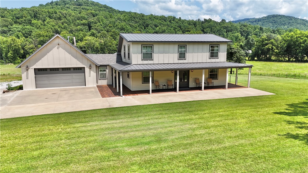 Farmhouse appeal with all the modern touches! Find timeless finishes and attention to detail in this 3224sqft, 3br/4ba home on 1.1 acres, completely remodeled w/addition in 2021. Indoors see bright, open living areas and room to entertain. Downstairs master, walk-in pantry, handy mud room, coffee bar, upstairs bath and 2 bedrooms, and abundant storage throughout. The bonus media room/living quarters is well-equipped with kitchenette, full bath, second washer/dryer, and dedicated entrance. Outdoors enjoy peaceful surroundings and panoramic mountain views from the covered porches. Notable extras include heated/cooled 2 car garage, utility garage, 2 attic storage areas w/lighting, spray foam insulation under roof decking, low maintenance exterior with full guttering. So many features making this property ideal for full-time living, a weekend getaway, or Airbnb. Additional adjoining 10 acres w/Fleming Creek frontage available. Highway frontage, fiber, natural gas, public water, no restrictions. A true Ozark gem!
